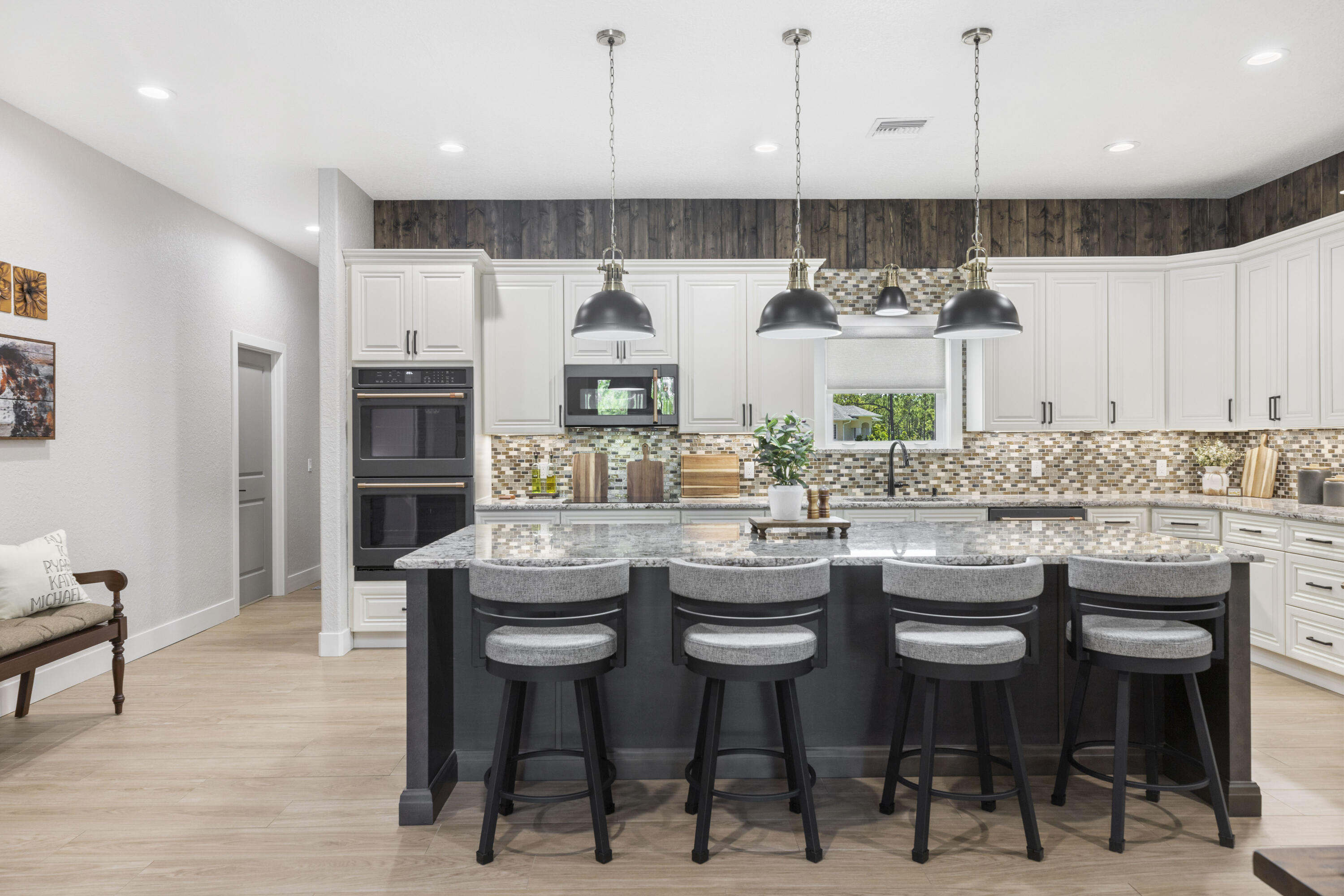 4544 Celestial Drive Grant Valkaria, FL 32949 - Photo 9 of 73 a kitchen with stainless steel appliances kitchen island granite countertop a table chairs sink and cabinets