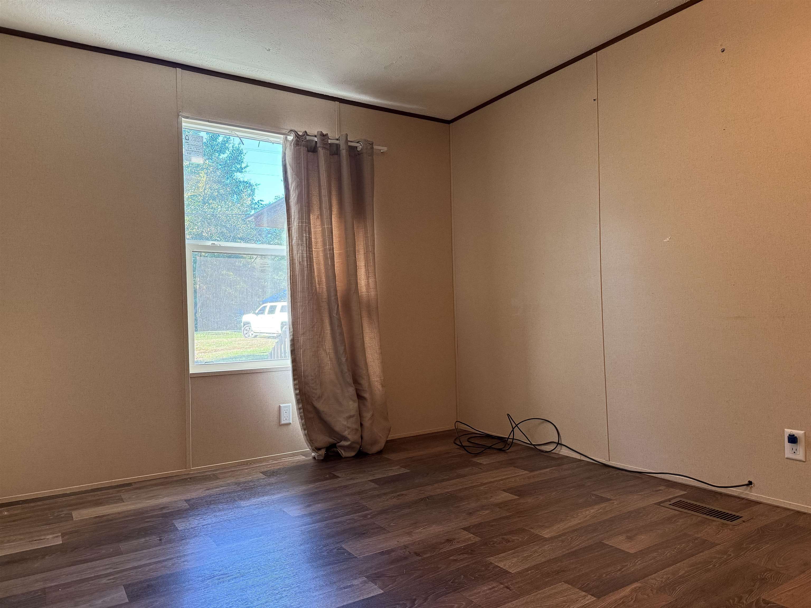 279 Travis Road Brewton, AL 36426 - Photo 10 of 17 Unfurnished room featuring dark wood finished floors and crown molding