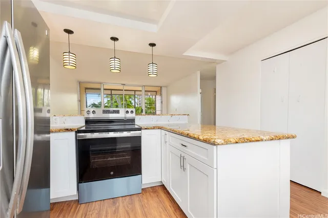 a kitchen with stainless steel appliances granite countertop a sink and a stove