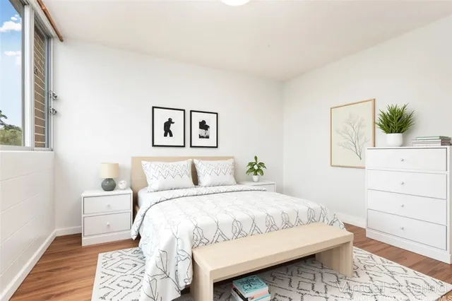 a bedroom with a bed and a window