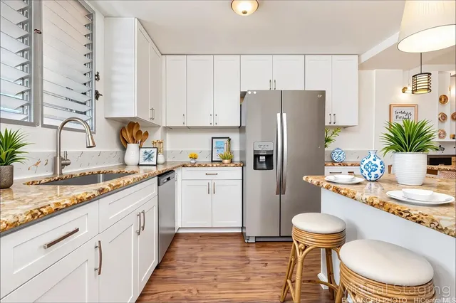 a kitchen with a sink a refrigerator and a stove top oven
