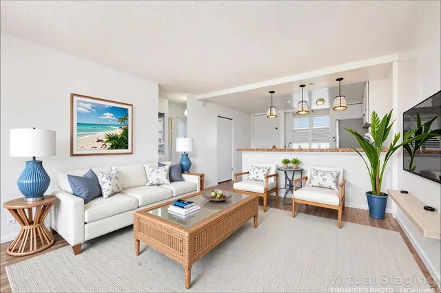 a living room with furniture potted plant and a flat screen tv