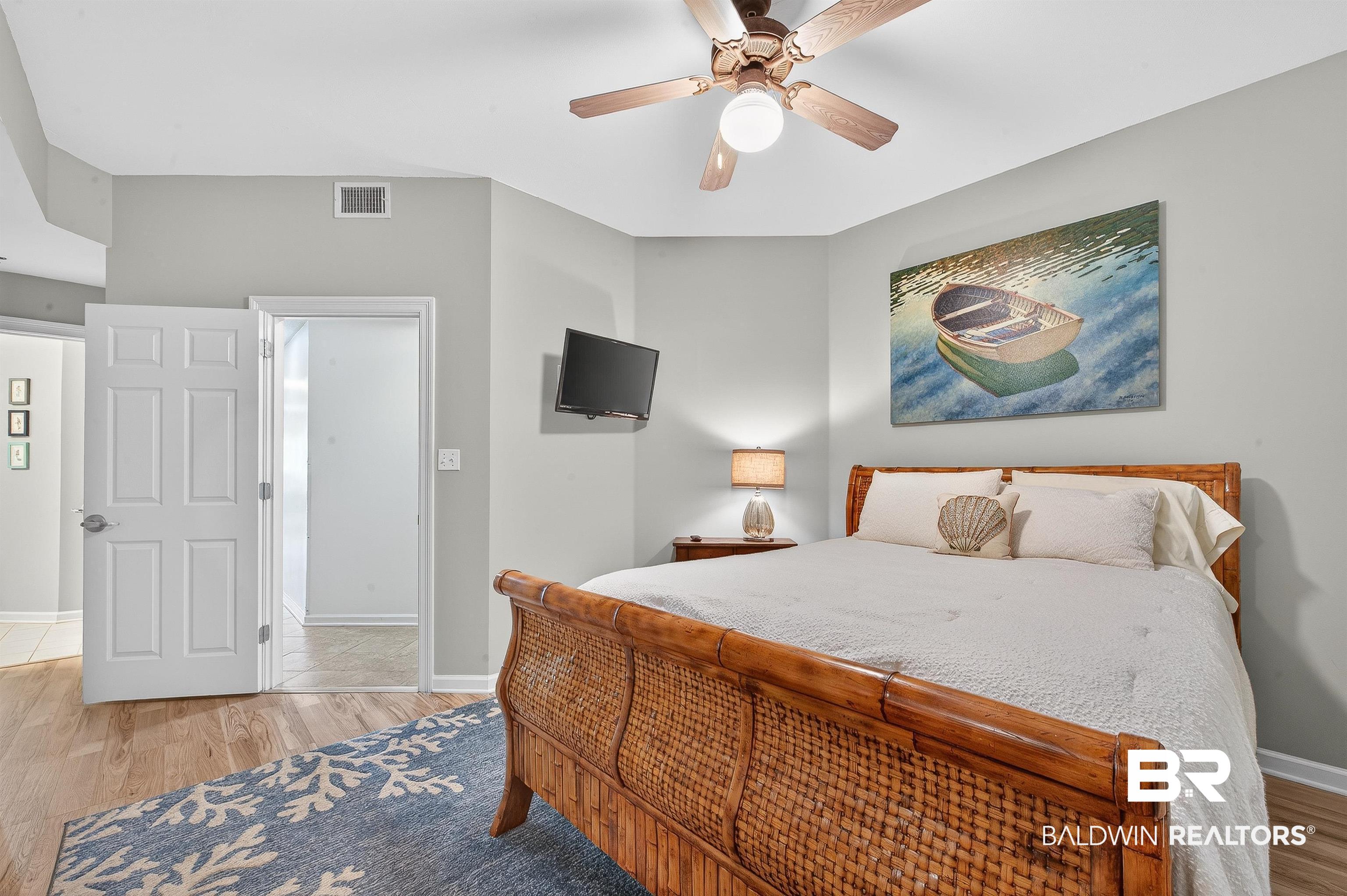 27282 Canal Road, Unit 408 Orange Beach, AL 36561 - Photo 14 of 37 Bedroom with light wood-style flooring and a ceiling fan