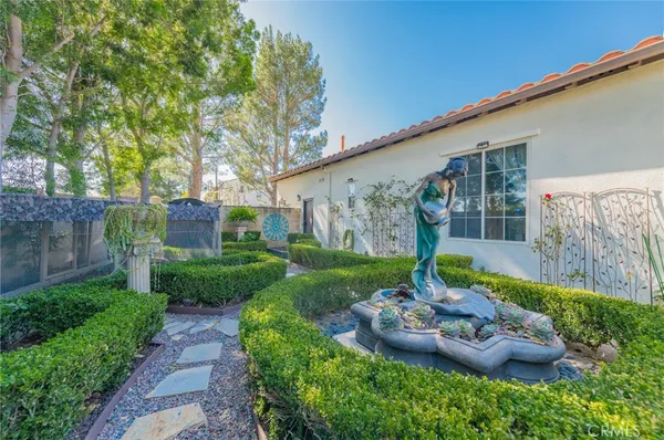 a view of a backyard with plants and a garden