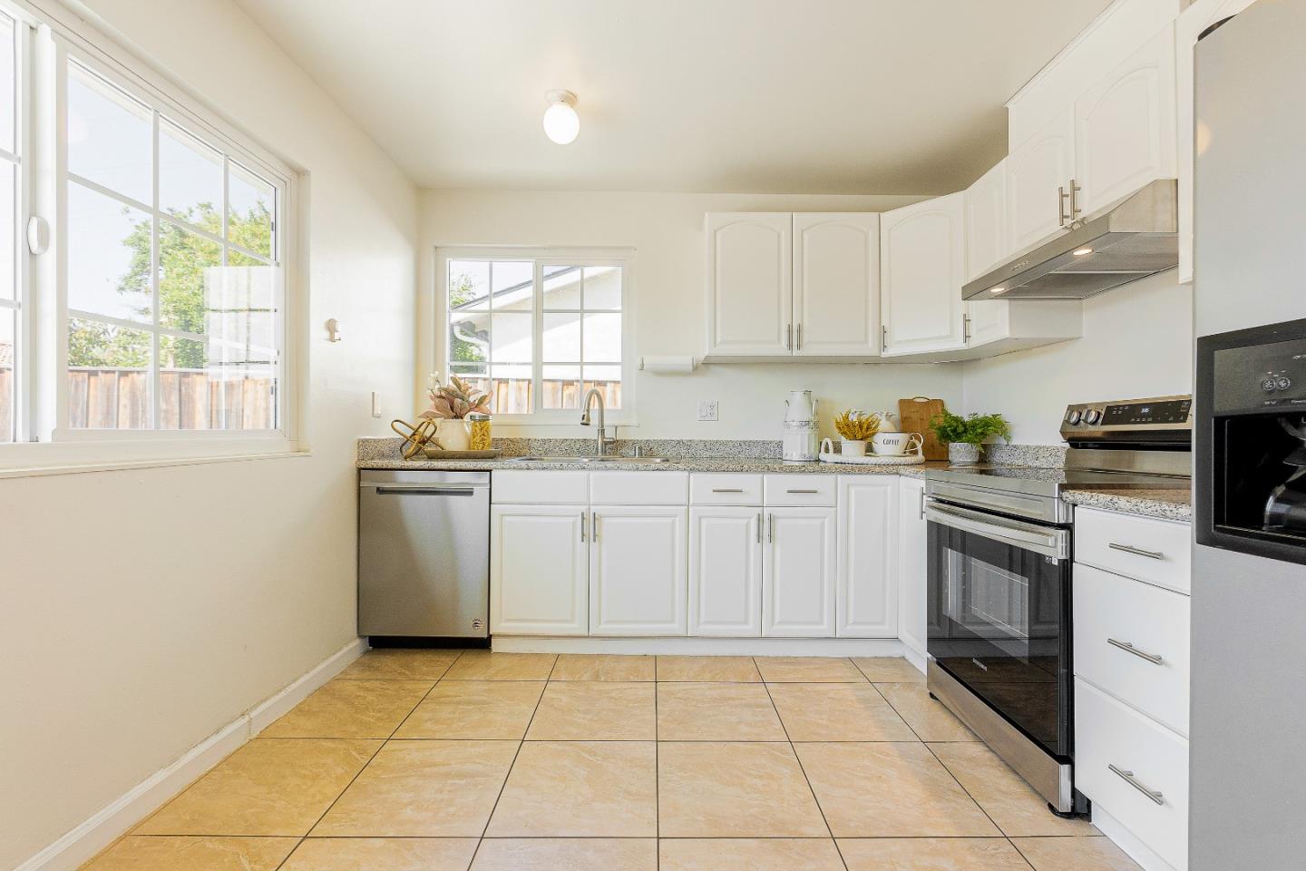 2051 Nunes Drive San Jose, CA 95131 - Photo 17 of 47 a kitchen with a sink a stove top oven and white cabinets