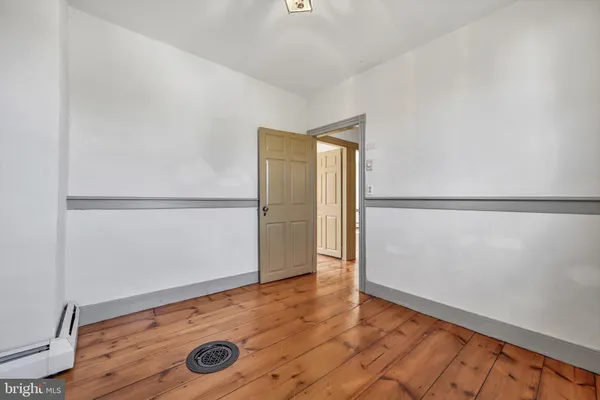 a view of a livingroom with wooden floor and a window