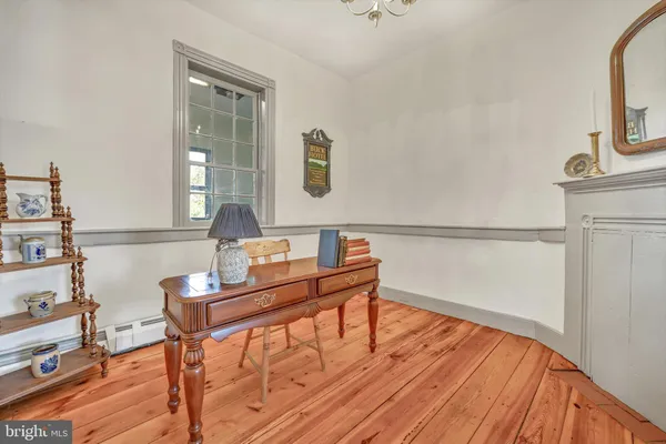 a living room with furniture a fireplace and wooden floor