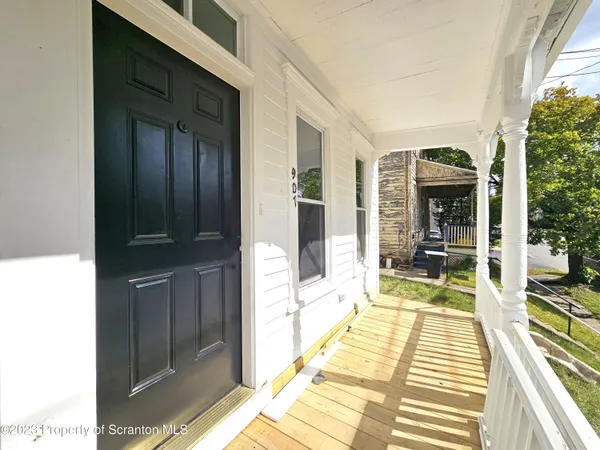 a view of a living room with furniture and floor to ceiling window