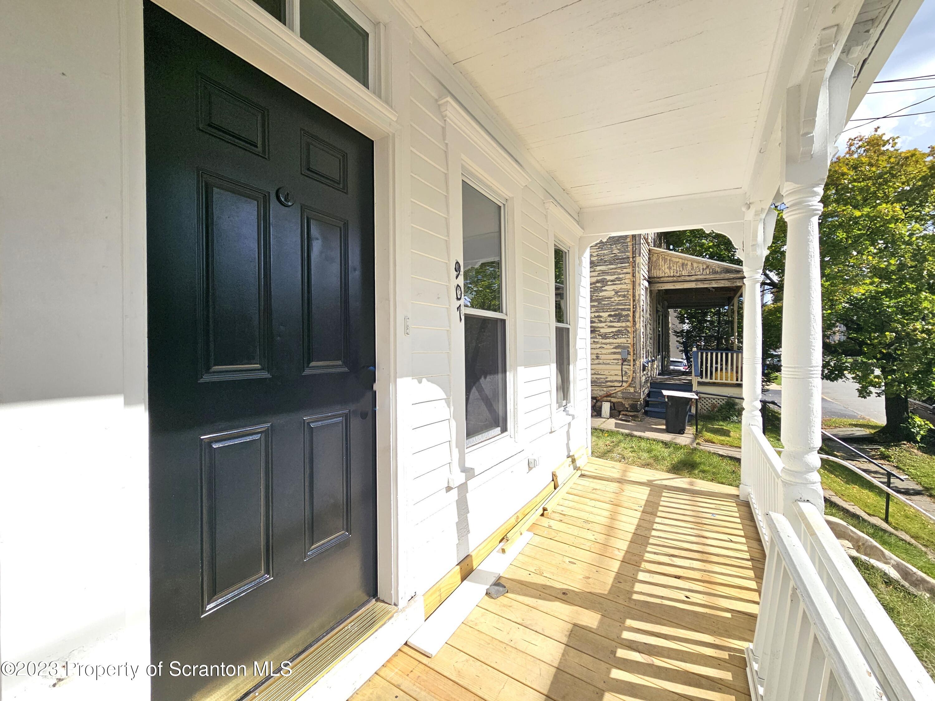 907 Green Ridge Street Scranton, PA 18509 - Photo 2 of 12 a view of a living room with furniture and floor to ceiling window