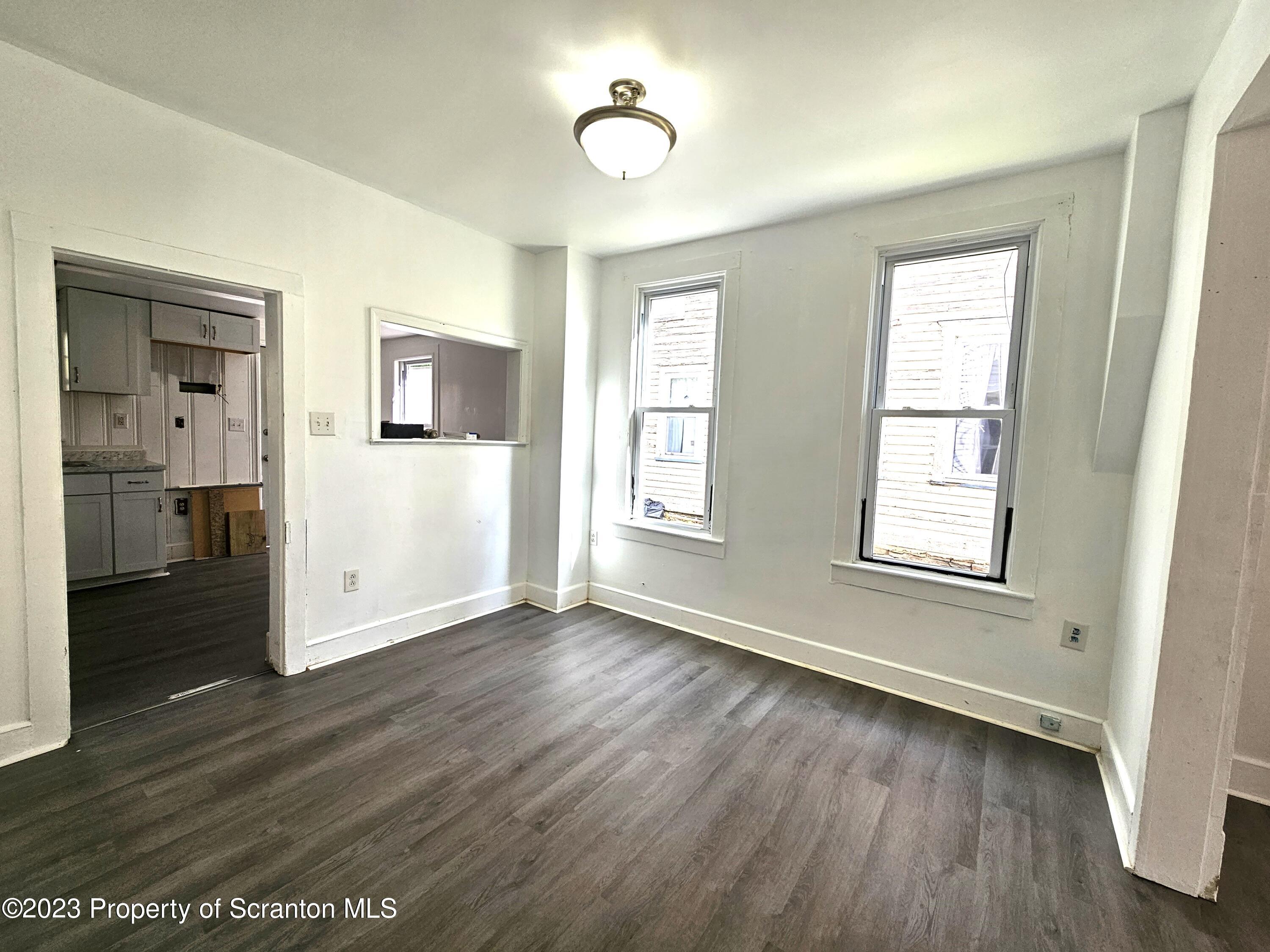 907 Green Ridge Street Scranton, PA 18509 - Photo 4 of 12 a view of livingroom with hardwood floor and window