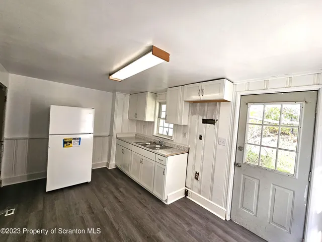 a kitchen with a stove a refrigerator and a stove