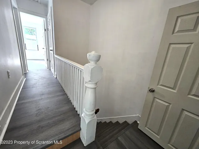 a view of a room with wooden floor and staircase