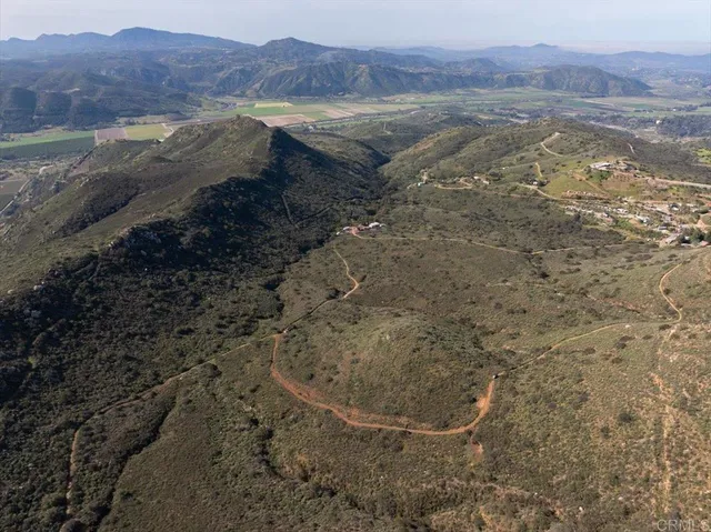 a view of dirt yard with a mountain