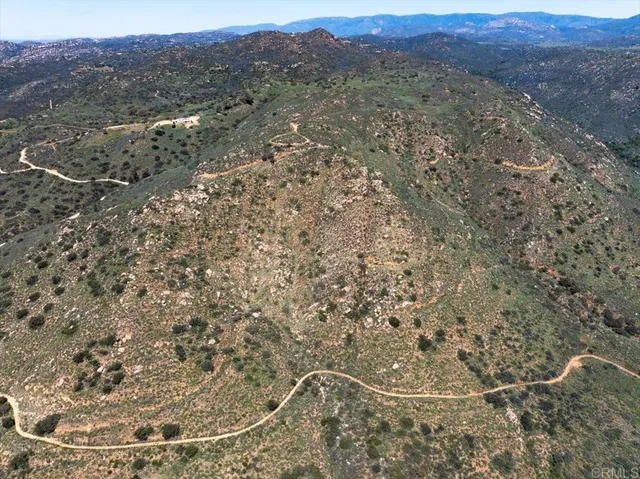 a view of a large mountains with a tree