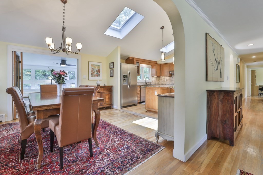 75 Valley Road Milton, MA 02186 - Photo 11 of 41 a view of a dining room with furniture wooden floor and a chandelier