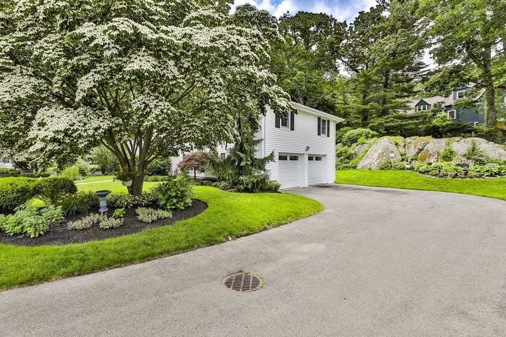 75 Valley Road Milton, MA 02186 - Photo 2 of 41 a front view of a house with a yard and garage