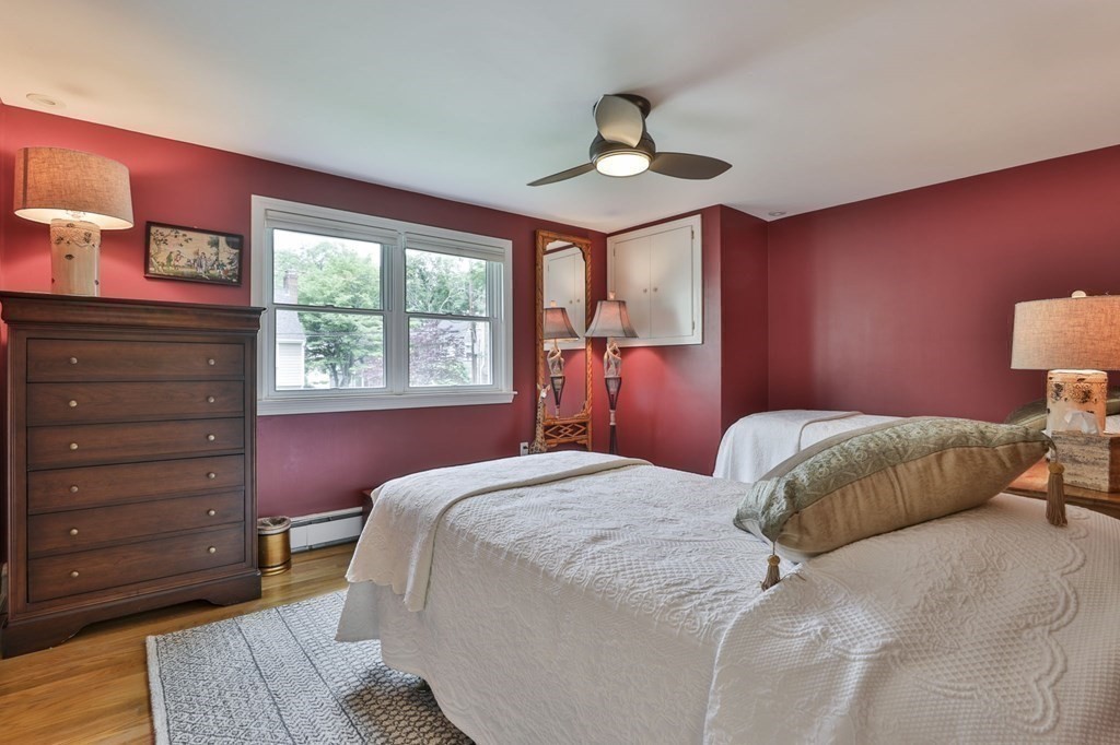 75 Valley Road Milton, MA 02186 - Photo 23 of 41 a bedroom with a bed and a chandelier