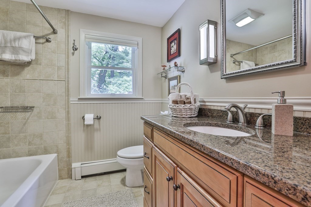 75 Valley Road Milton, MA 02186 - Photo 24 of 41 a bathroom with a granite countertop sink a toilet and bathtub