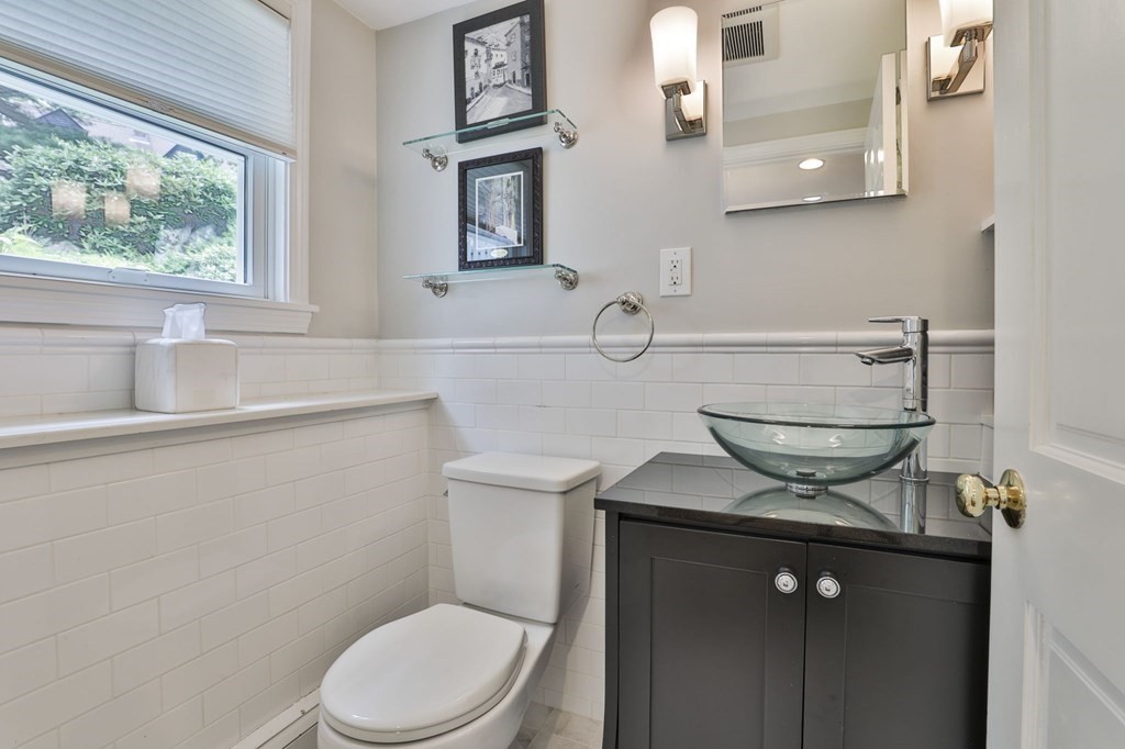 75 Valley Road Milton, MA 02186 - Photo 30 of 41 a bathroom with a sink a toilet and a window