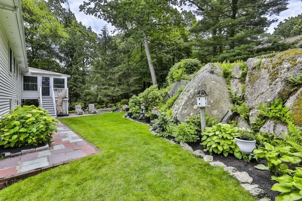75 Valley Road Milton, MA 02186 - Photo 35 of 41 a view of a garden with large trees