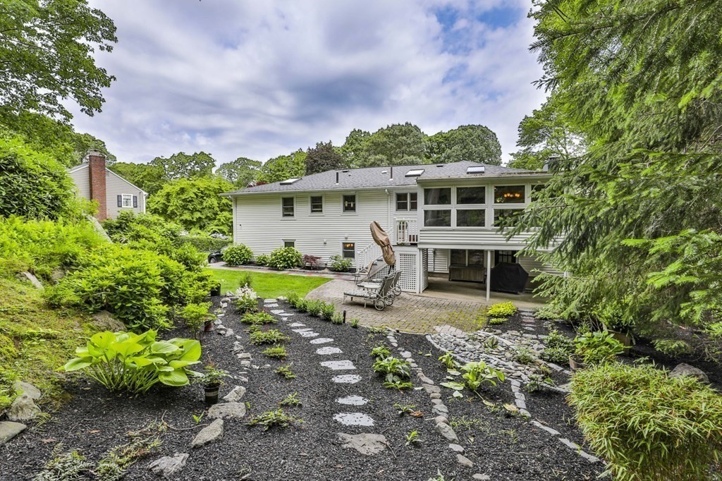 75 Valley Road Milton, MA 02186 - Photo 37 of 41 a view of a house with backyard sitting area and garden