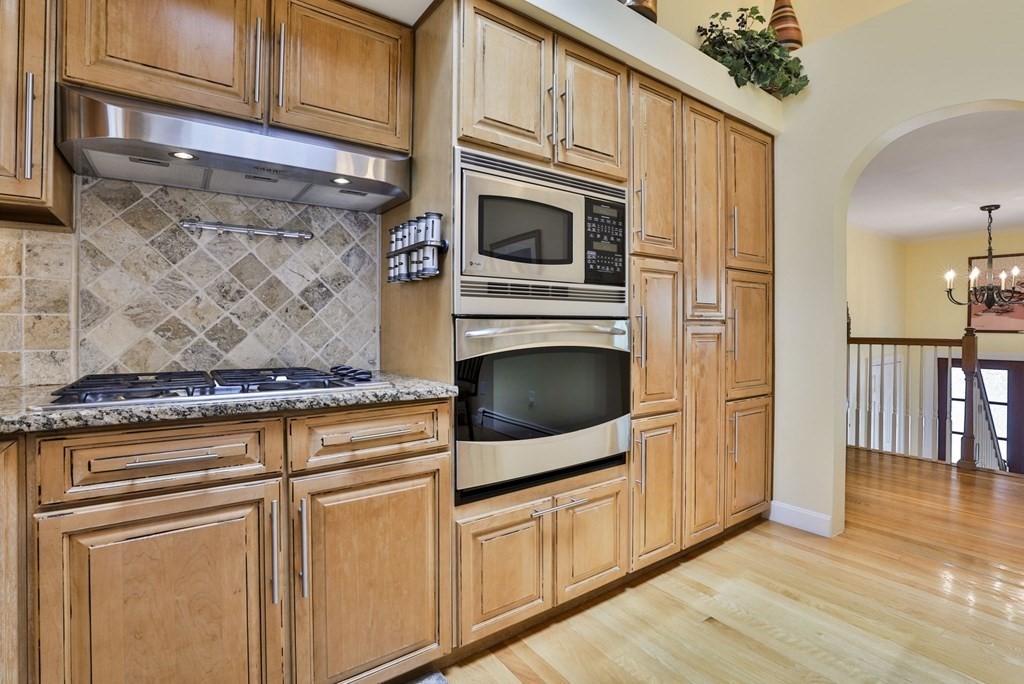 75 Valley Road Milton, MA 02186 - Photo 8 of 41 a kitchen with stainless steel appliances granite countertop a stove and a microwave