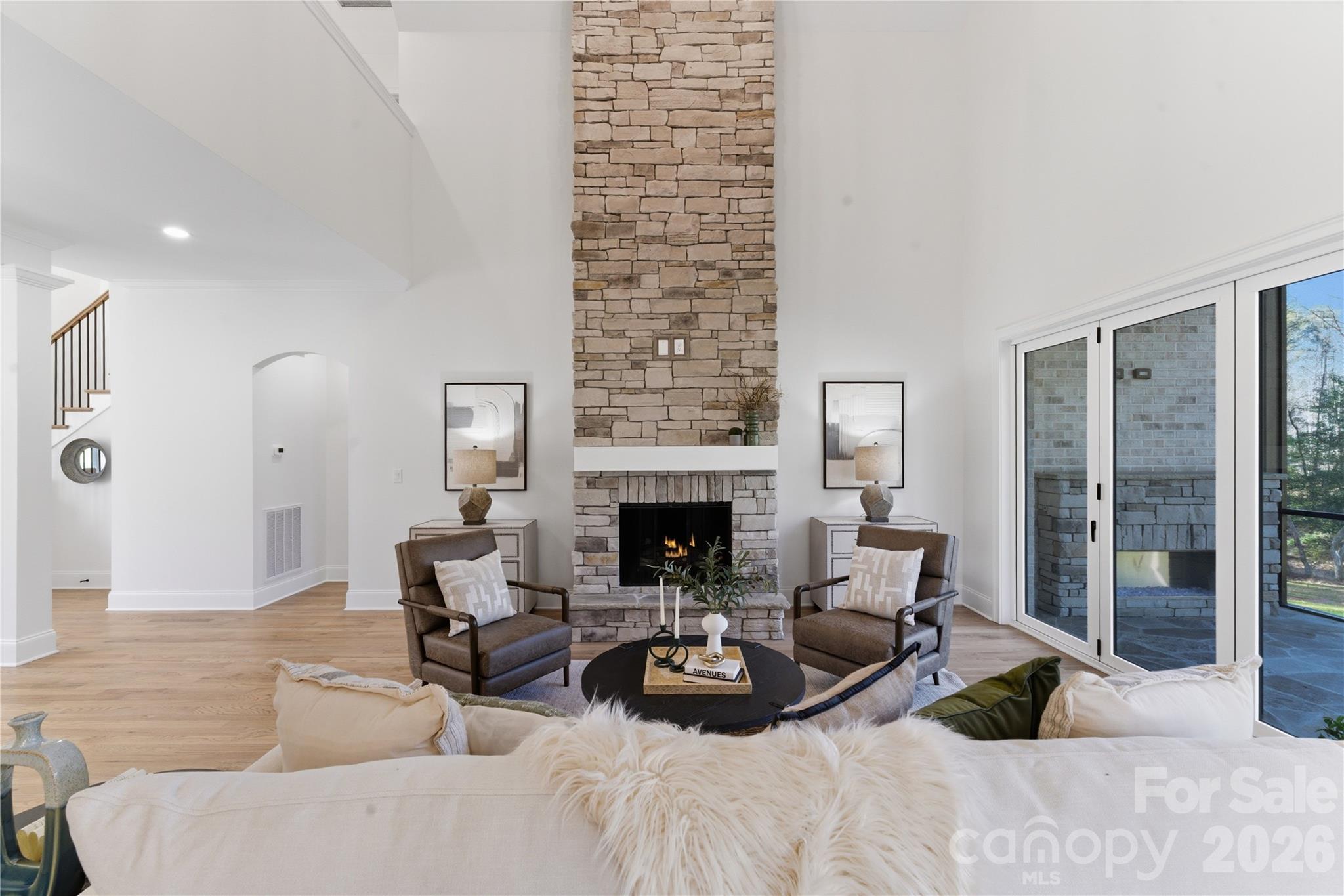 6405 Chimney Bluff Road Lancaster, SC 29720 - Photo 12 of 38 a living room with furniture potted plant a fireplace and a large window