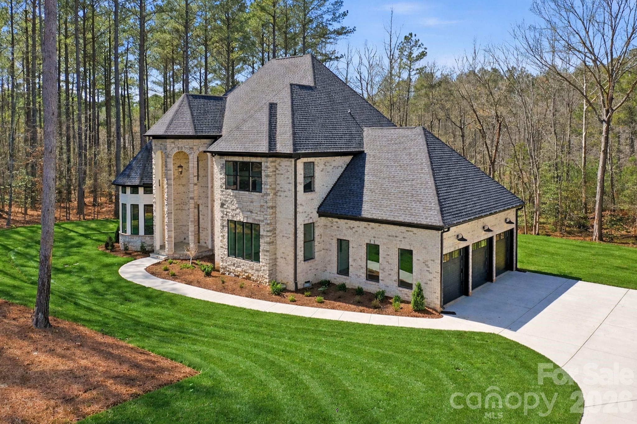 6405 Chimney Bluff Road Lancaster, SC 29720 - Photo 2 of 38 a aerial view of a house with table and chairs under an umbrella