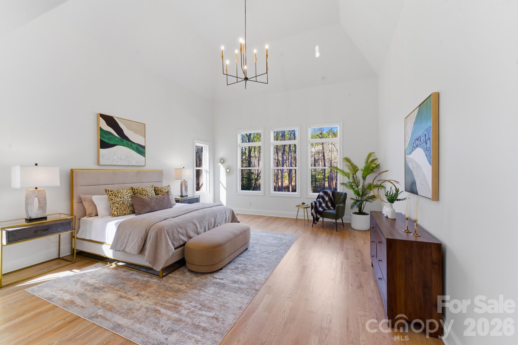 6405 Chimney Bluff Road Lancaster, SC 29720 - Photo 22 of 38 a spacious bedroom with a balcony a bed and a chandelier