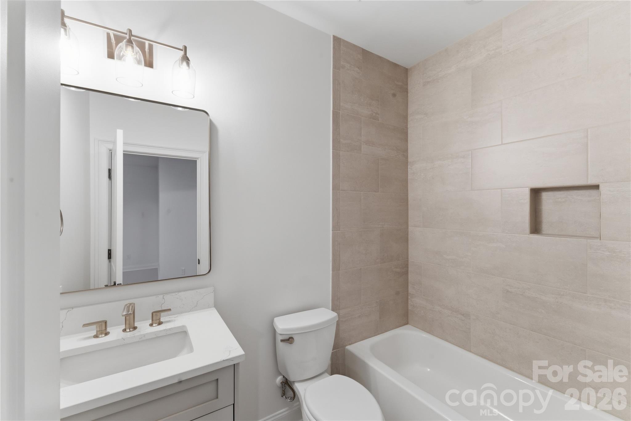 6405 Chimney Bluff Road Lancaster, SC 29720 - Photo 31 of 38 a bathroom with a sink mirror vanity and toilet