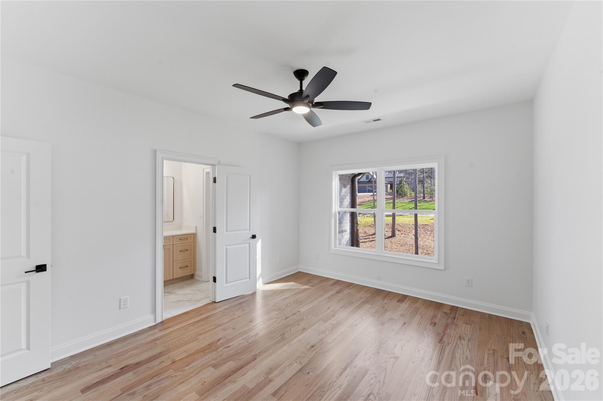 6405 Chimney Bluff Road Lancaster, SC 29720 - Photo 32 of 38 a view of an empty room with a window and wooden floor