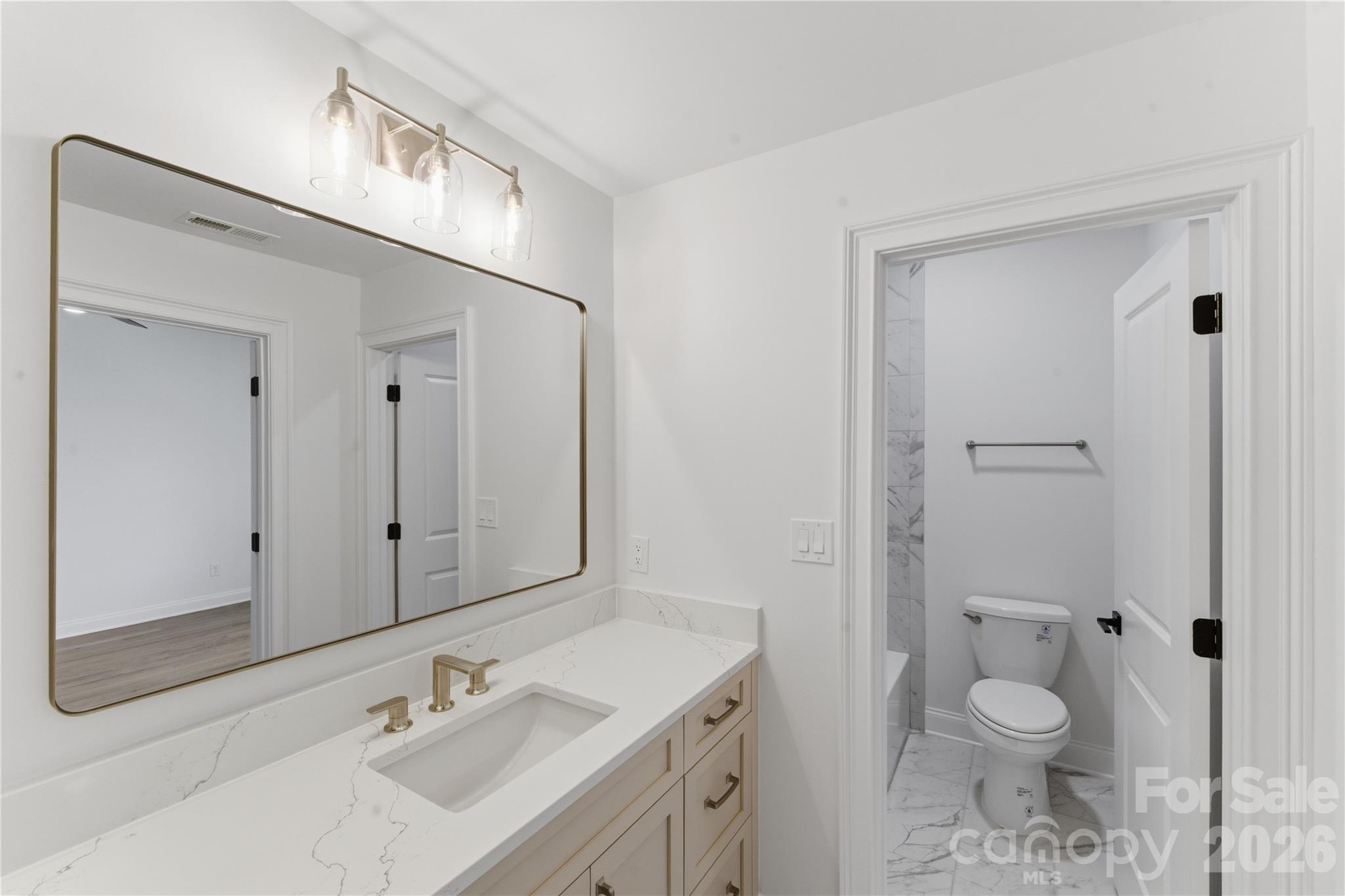 6405 Chimney Bluff Road Lancaster, SC 29720 - Photo 33 of 38 a bathroom with a granite countertop sink toilet and shower