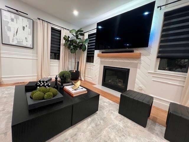 6 Rivendell Lane Millis, MA 02054 - Photo 13 of 41 a living room with furniture a flat screen tv and a fireplace