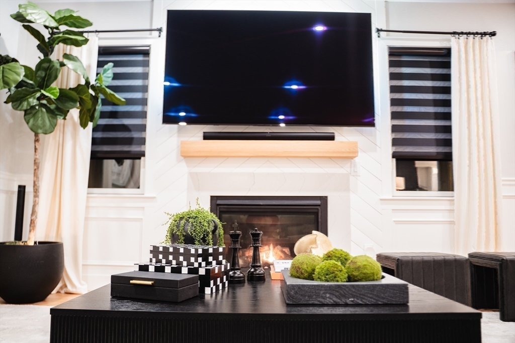 6 Rivendell Lane Millis, MA 02054 - Photo 14 of 41 a living room with furniture and a fireplace