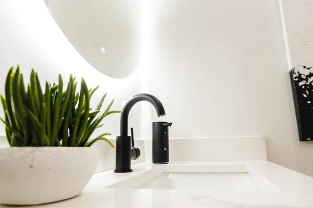 a bathroom with a tub sink and mirror