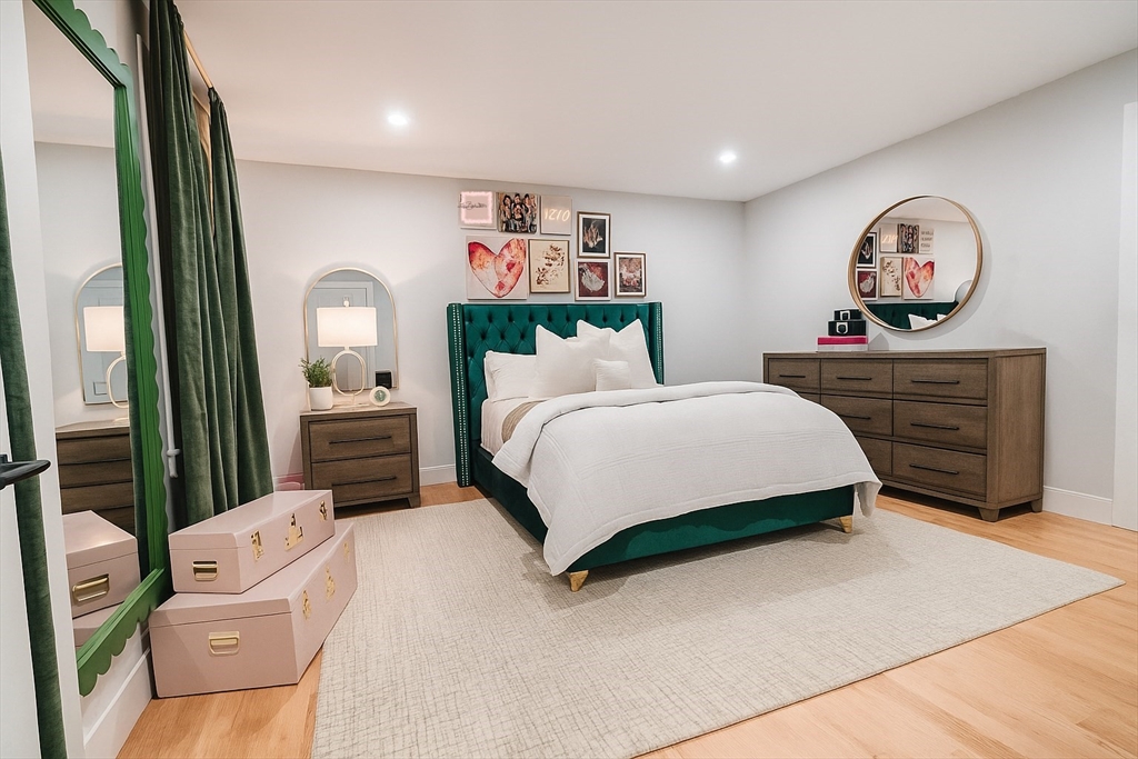 6 Rivendell Lane Millis, MA 02054 - Photo 24 of 41 a bedroom with a bed and a chandelier