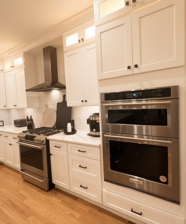 6 Rivendell Lane Millis, MA 02054 - Photo 7 of 41 a kitchen with stainless steel appliances granite countertop a stove microwave and cabinets