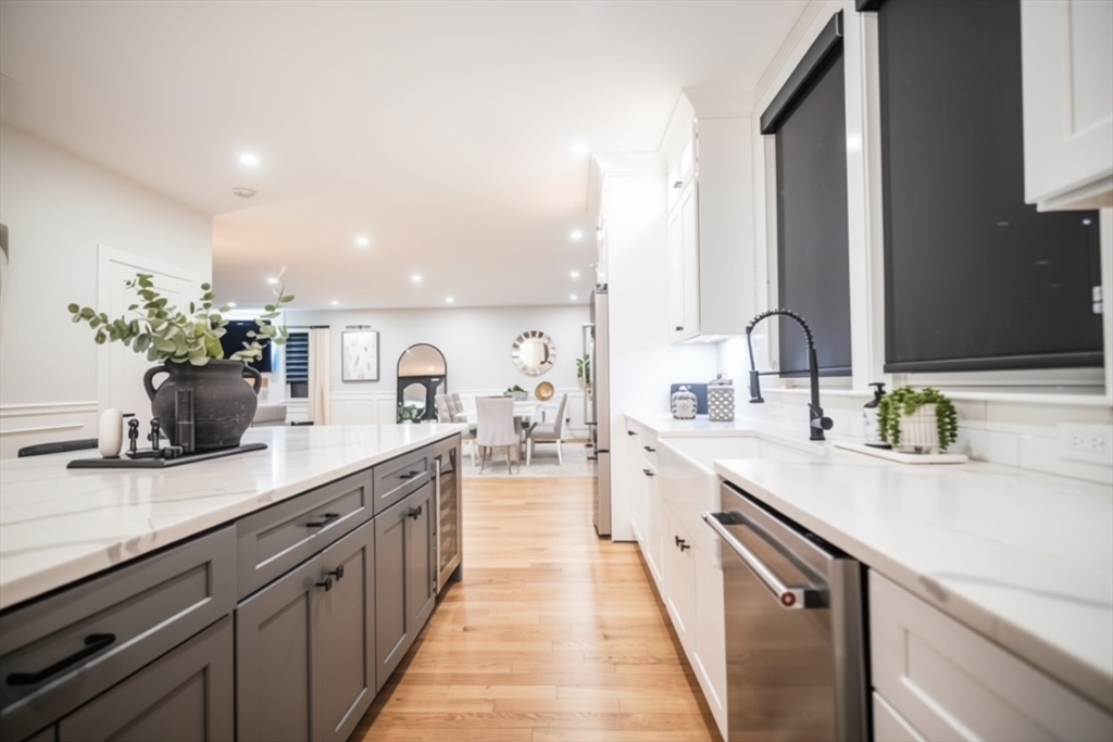 6 Rivendell Lane Millis, MA 02054 - Photo 8 of 41 a large kitchen with kitchen island granite countertop a sink and cabinets