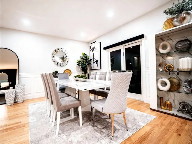 a living room with furniture and painting on the wall