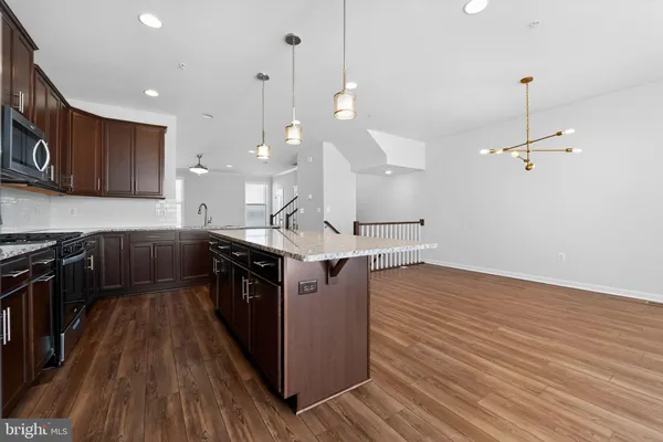a kitchen with a sink and wooden floor