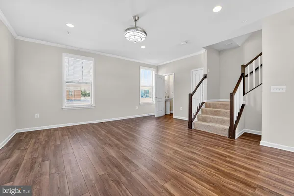 a view of entryway with wooden floor and stairs