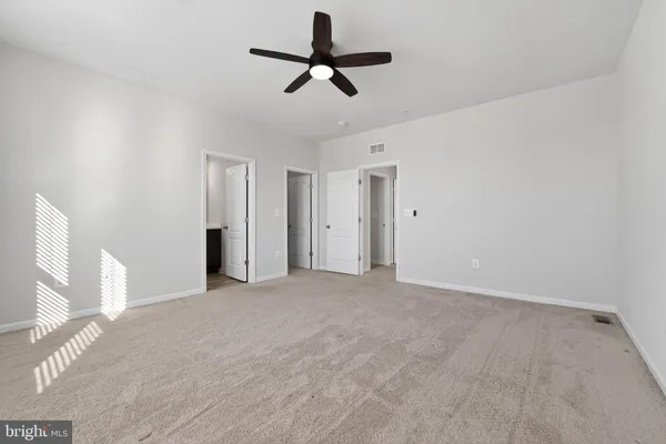a view of a livingroom with a ceiling fan window and hardwood floor