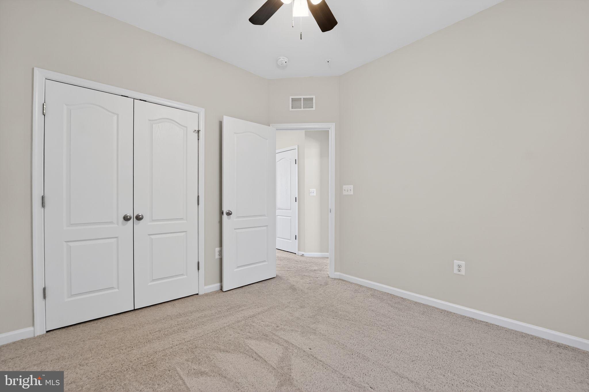 304 Faversham Place Frederick, MD 21701 - Photo 28 of 32 an empty room with chandelier fan