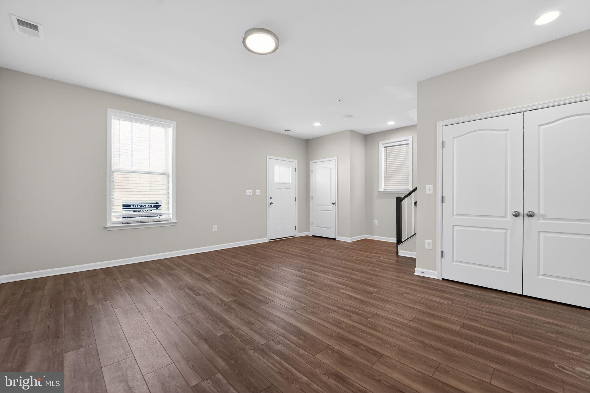 304 Faversham Place Frederick, MD 21701 - Photo 4 of 32 an empty room with wooden floor and windows