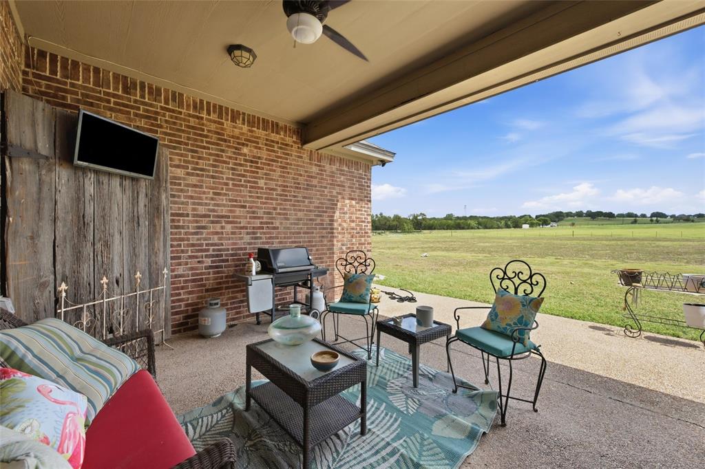 845 County Line Road West West, TX 76691 - Photo 28 of 36 Covered patio with brick exterior, concrete flooring, and an outdoor ceiling fan