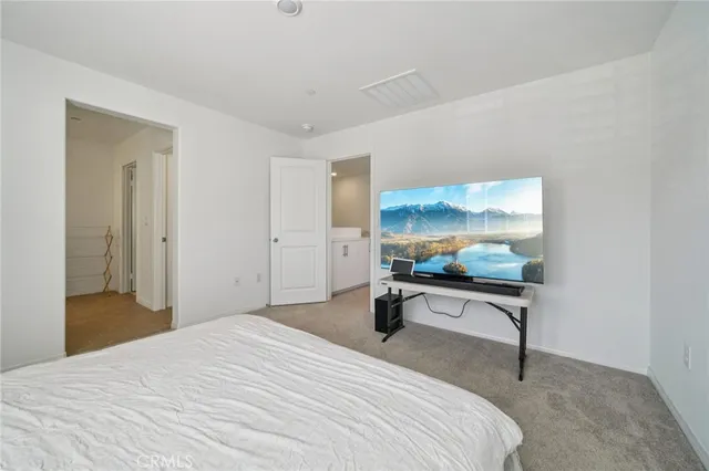 a bedroom with a bed and a desk