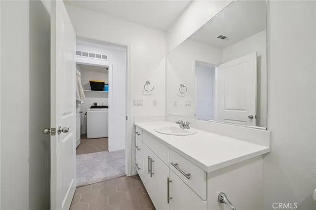 a spacious bathroom with a sink and a mirror