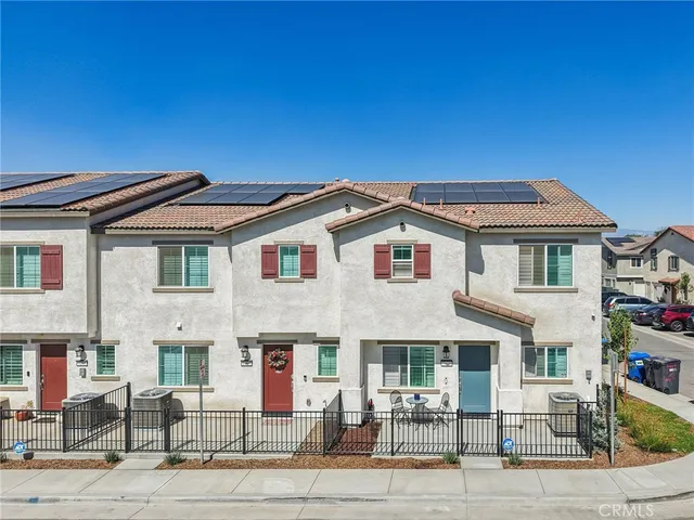 a front view of a building with multiple trees