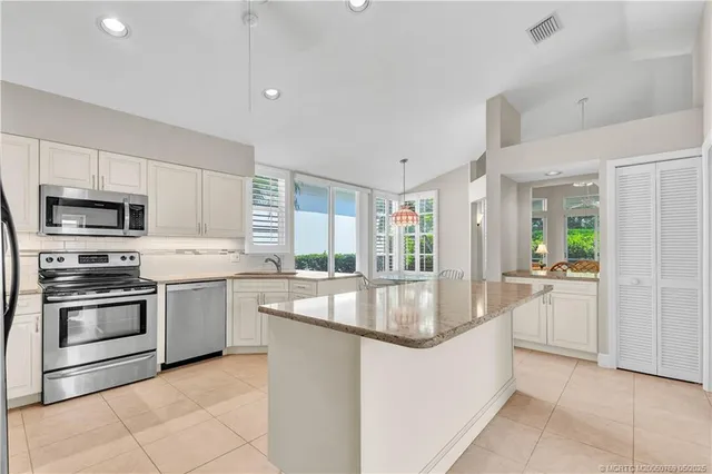 a kitchen with stainless steel appliances granite countertop a lot of counter top space