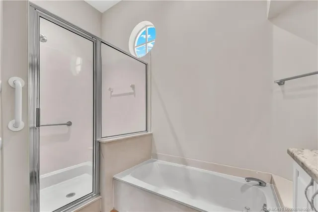a bathroom with a bathtub and a shower